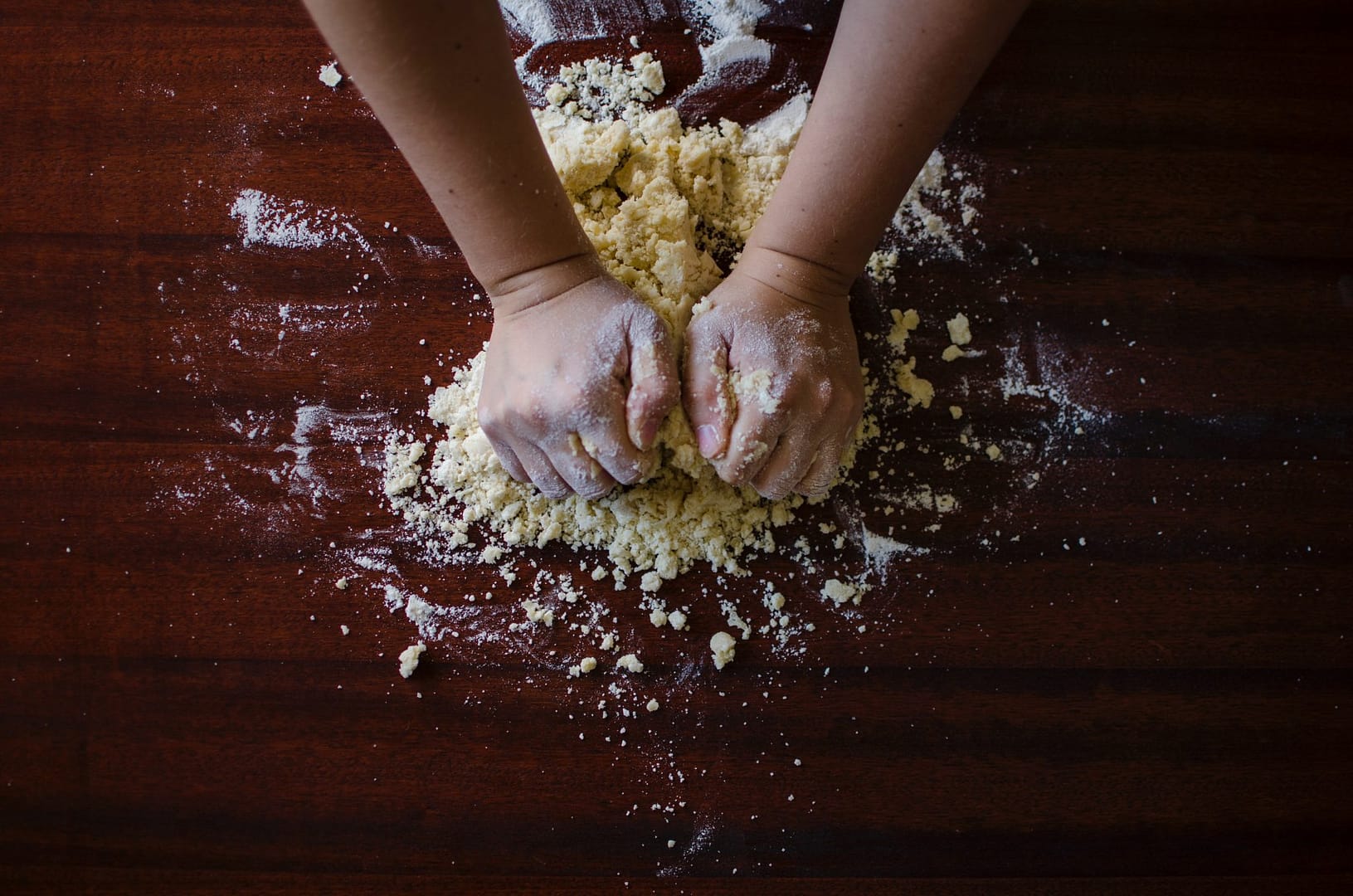 Mixing dough with both hands for baking
